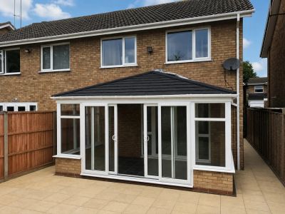 Same conservatory with new solid charcoal tiled warm roof